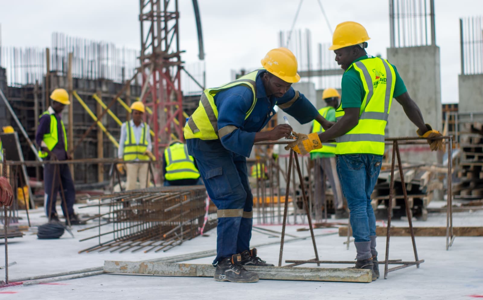 Site engineers fixing steel reinforcement on an active construction site